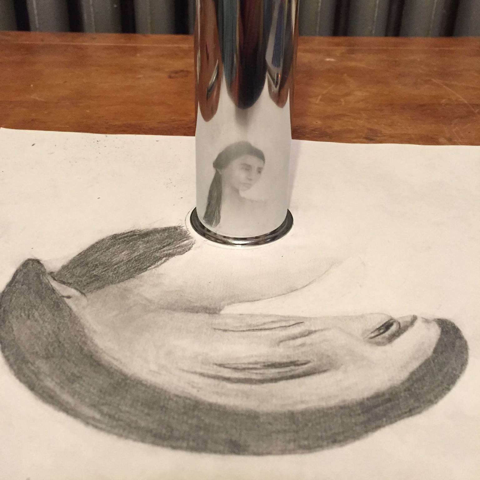 cylinder reflection showing a drawing of a woman